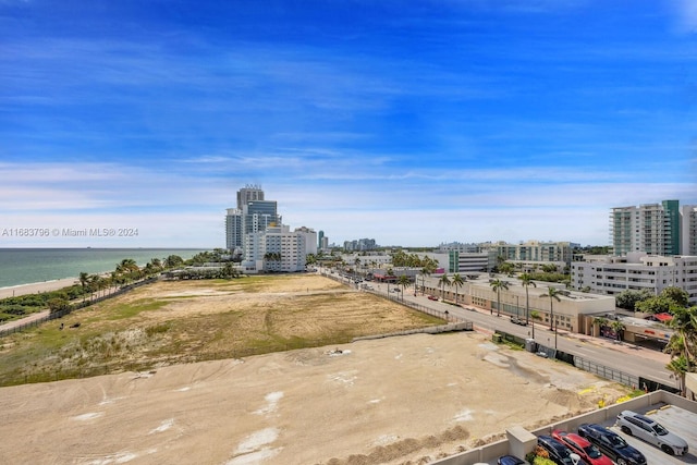 birds eye view of property featuring a water view and a view of the beach