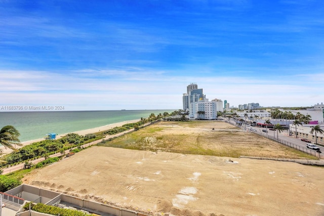 bird's eye view with a water view and a beach view