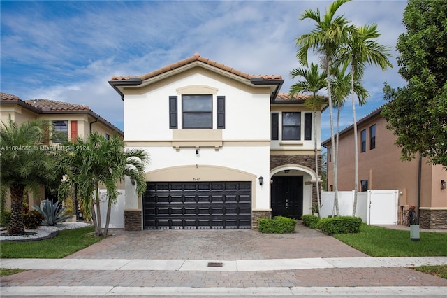 mediterranean / spanish home featuring a garage