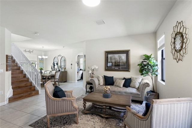 tiled living room featuring a notable chandelier