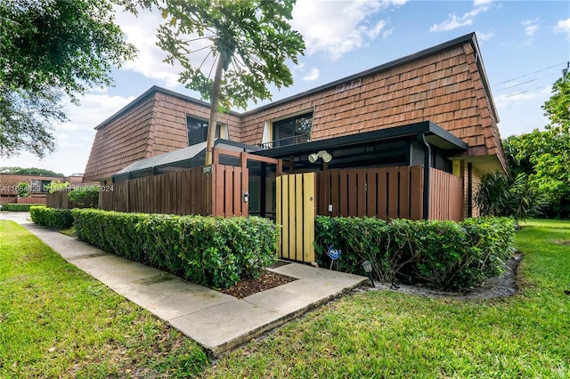 view of side of property with a lawn