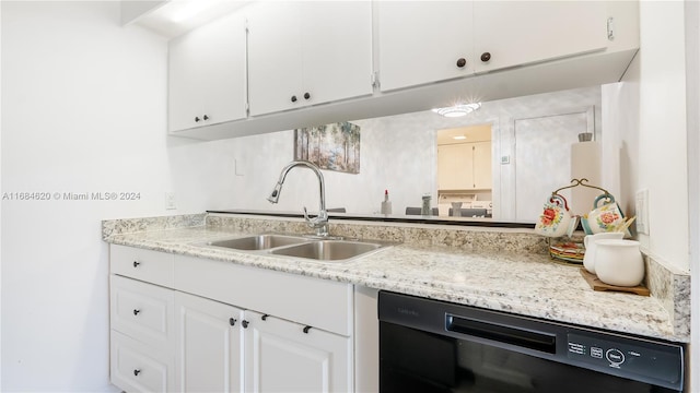 kitchen with black dishwasher, sink, and white cabinets