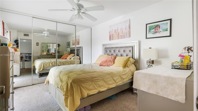 bedroom with a closet, light colored carpet, and ceiling fan