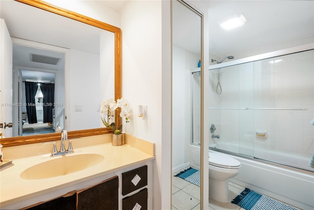 full bathroom with vanity, toilet, tile patterned floors, and shower / bath combination with glass door