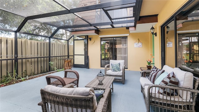 view of patio / terrace featuring an outdoor hangout area and glass enclosure