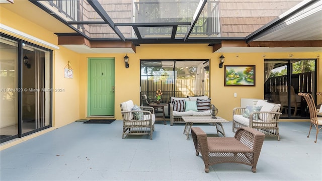 view of patio with an outdoor living space and a balcony