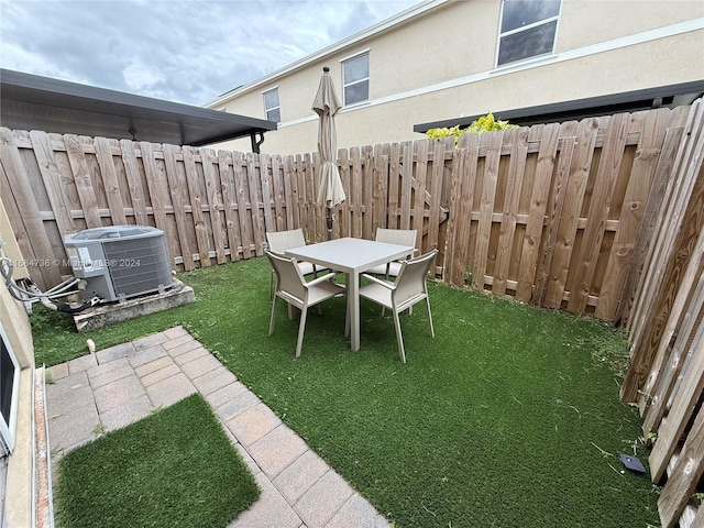 view of yard with cooling unit and a patio