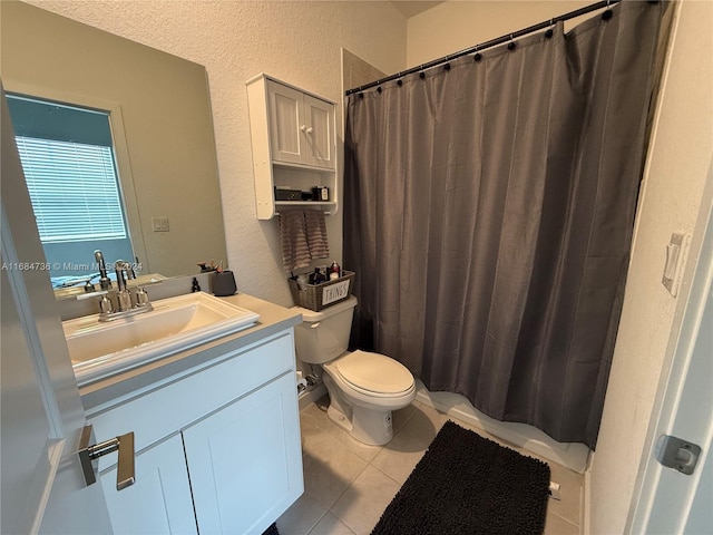 bathroom with toilet, walk in shower, vanity, and tile patterned floors