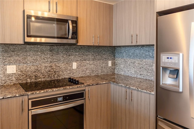 kitchen featuring light brown cabinets, stainless steel appliances, tasteful backsplash, and stone countertops