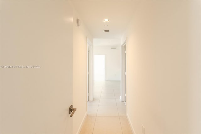 hall featuring light tile patterned flooring