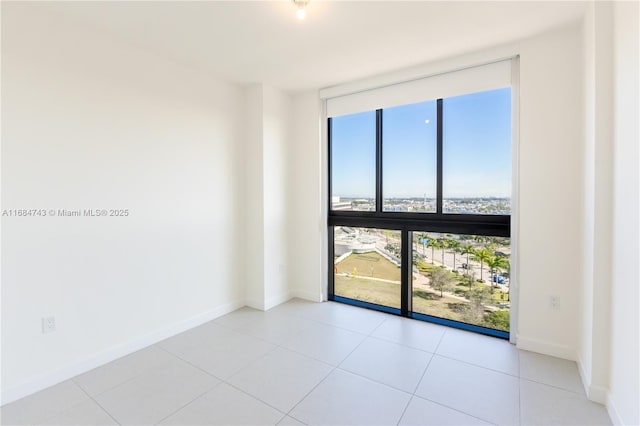 tiled spare room with expansive windows