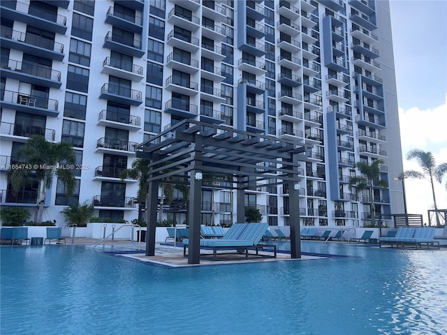 view of swimming pool featuring a patio area and a water view