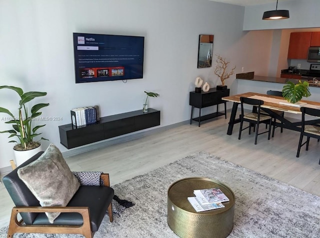 1200 Brickell Bay Dr Unit Ph4204, Miami, FL 33131 - living room featuring light wood-style flooring and baseboards