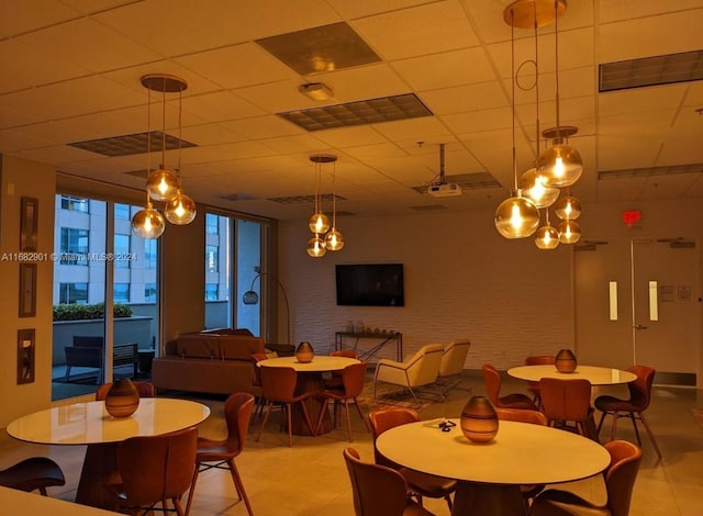 dining space with a paneled ceiling