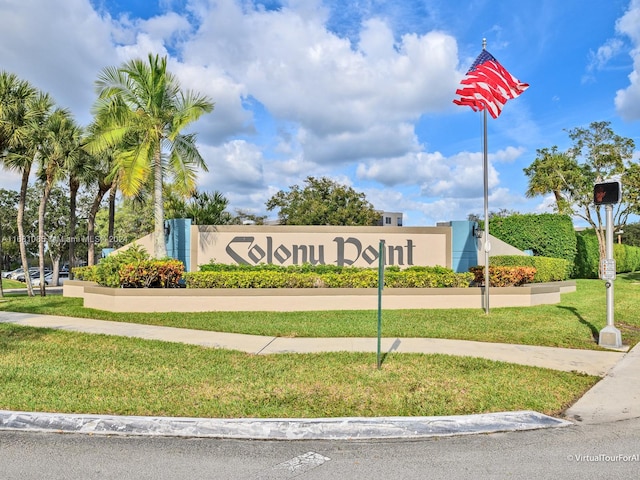 community sign featuring a yard