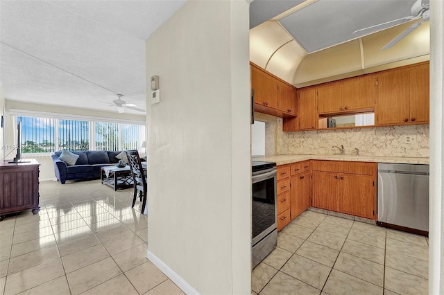 330 SE 2nd St Unit 303F, Hallandale Beach, FL 33009 - kitchen featuring a ceiling fan, light countertops, a sink, open floor plan, and stainless steel appliances