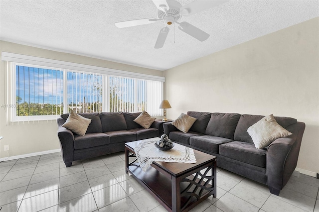 tiled living room with ceiling fan, a textured ceiling, and plenty of natural light