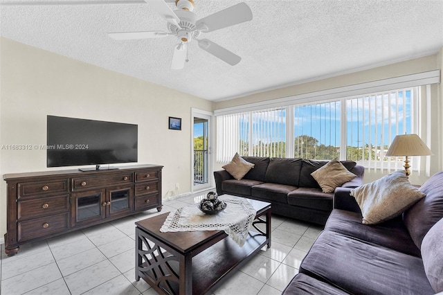 tiled living room with ceiling fan and a textured ceiling