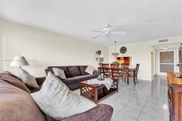 330 SE 2nd St Unit 303F, Hallandale Beach, FL 33009 - living area featuring light tile patterned flooring, a textured ceiling, a ceiling fan, baseboards, and visible vents