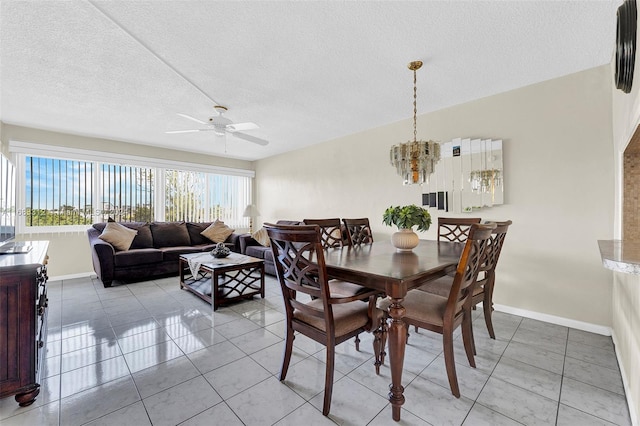 dining space with a textured ceiling, tile patterned flooring, and ceiling fan