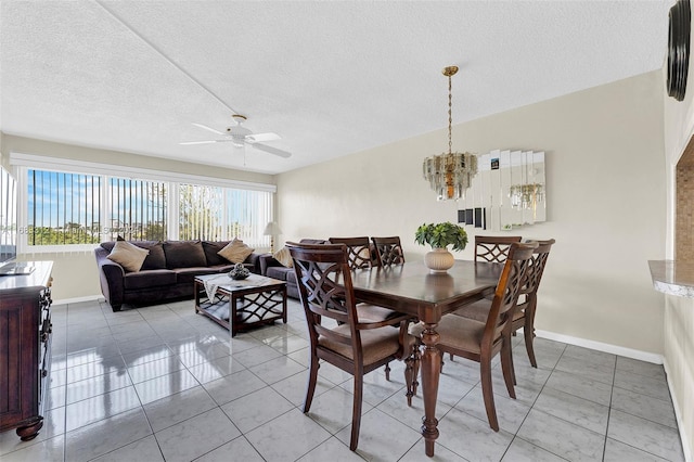 330 SE 2nd St Unit 303F, Hallandale Beach, FL 33009 - dining space featuring baseboards, ceiling fan with notable chandelier, a textured ceiling, and light tile patterned flooring