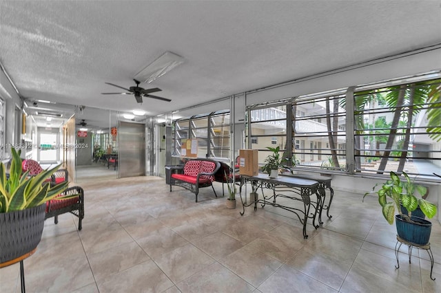 sunroom featuring ceiling fan