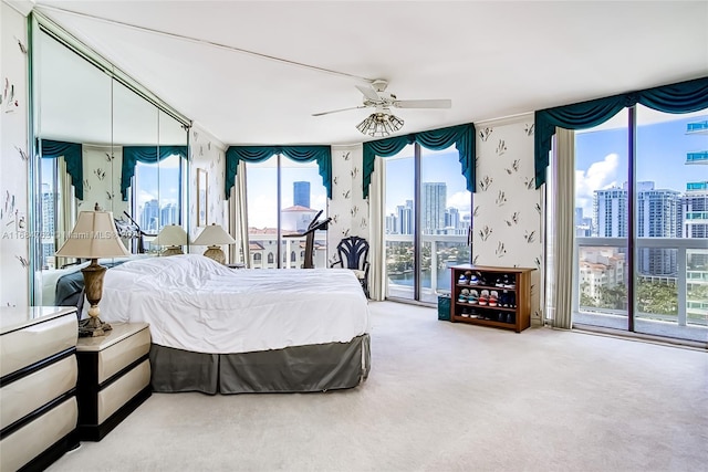 bedroom with carpet flooring, access to outside, and ceiling fan