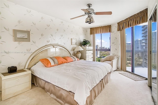 carpeted bedroom with access to exterior and ceiling fan