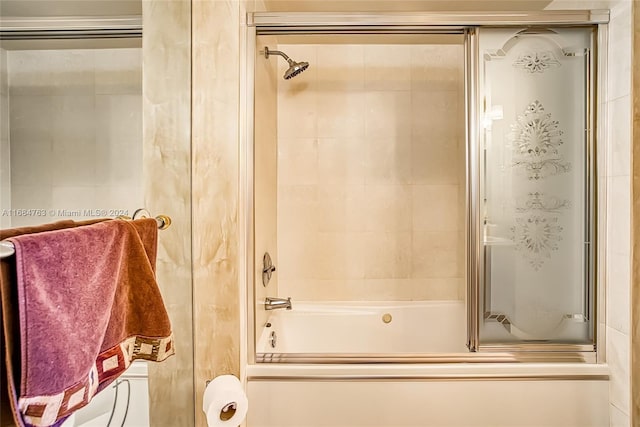 bathroom featuring combined bath / shower with glass door