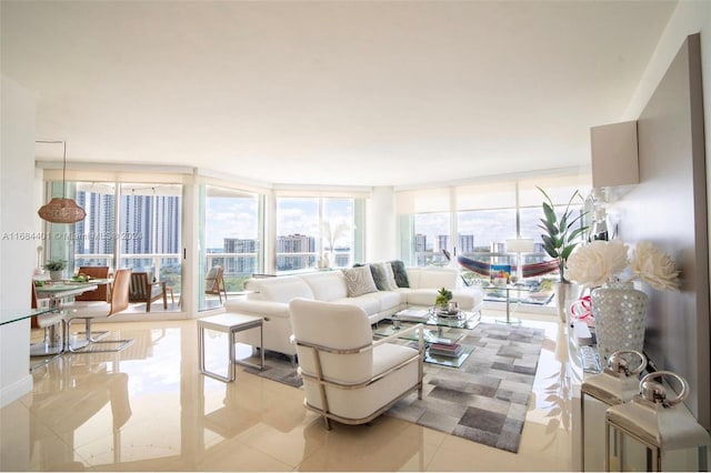 living room with a wall of windows and light tile patterned flooring