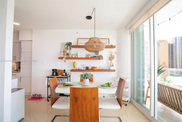 dining space with plenty of natural light and light tile patterned floors