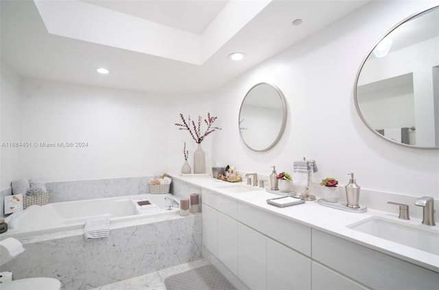 bathroom featuring vanity, tile patterned floors, and tiled bath