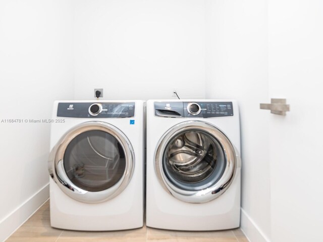 washroom with light hardwood / wood-style flooring and separate washer and dryer