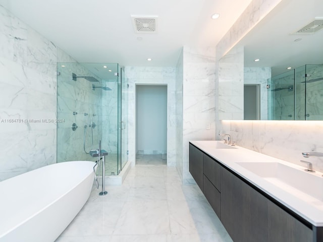 bathroom featuring vanity, plus walk in shower, and tile walls