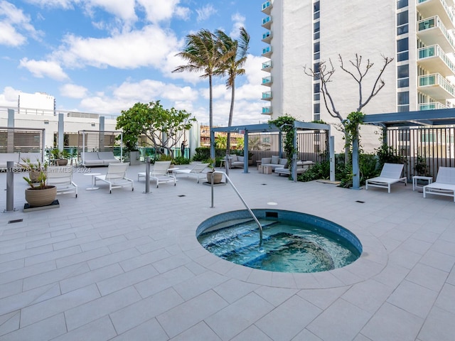 view of pool with a community hot tub and a patio