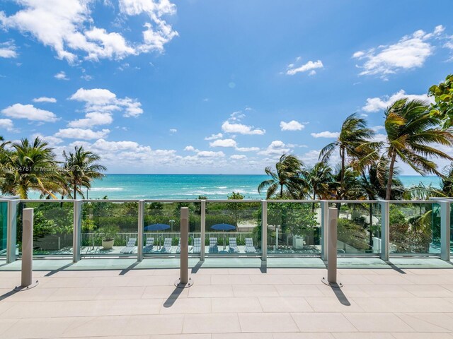 exterior space with a water view and a view of the beach