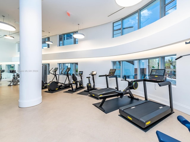 gym featuring a towering ceiling