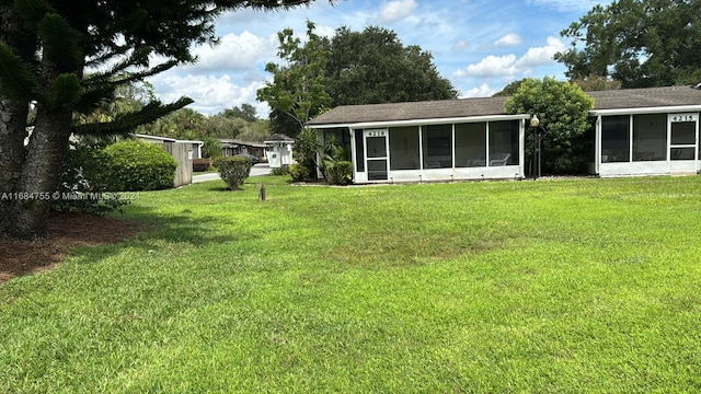 view of yard with a sunroom