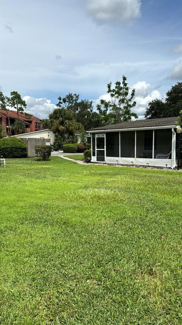 view of yard featuring a sunroom