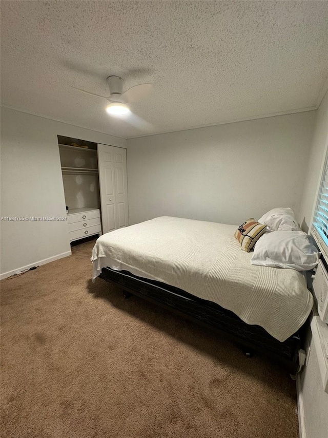 carpeted bedroom featuring a textured ceiling, a closet, and ceiling fan