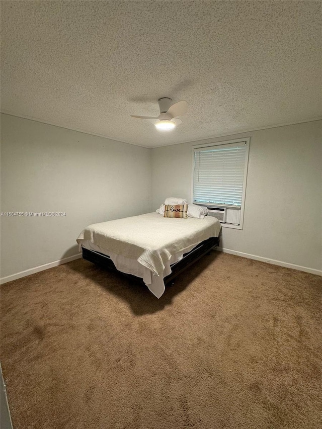 unfurnished bedroom with a textured ceiling, carpet flooring, and ceiling fan