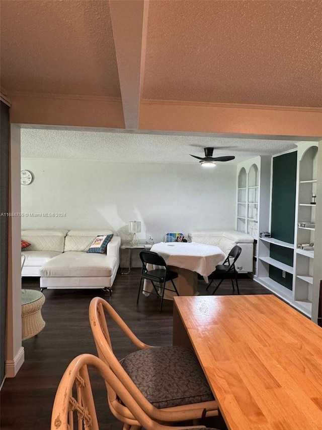 interior space with hardwood / wood-style floors, ceiling fan, beamed ceiling, and a textured ceiling