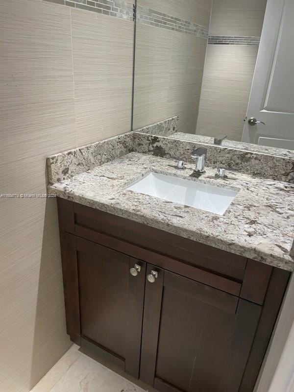 bathroom featuring tile walls and vanity