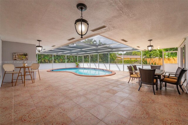 view of pool with a patio area and a lanai