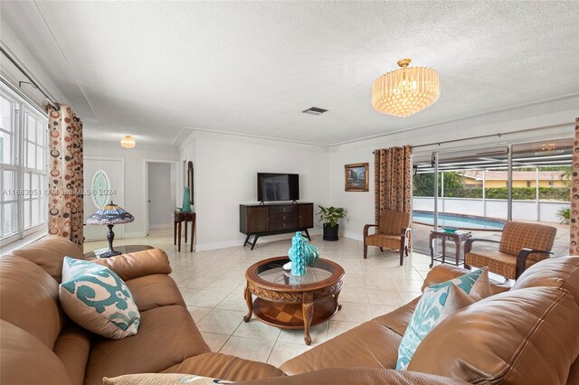 living room with a healthy amount of sunlight, ornamental molding, light tile patterned flooring, and a textured ceiling