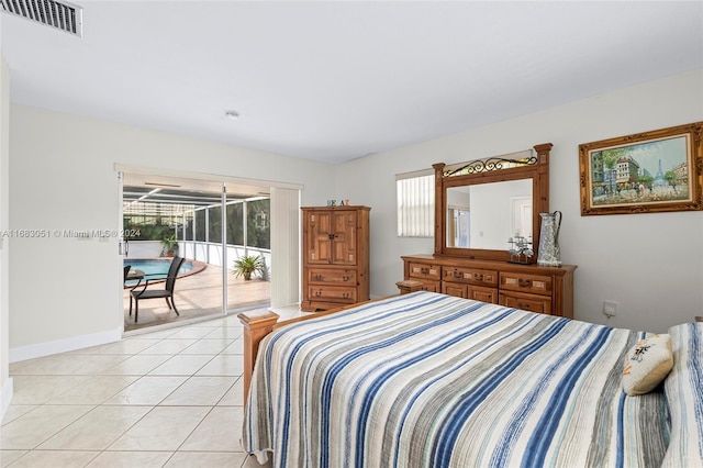 bedroom featuring light tile patterned floors and access to exterior