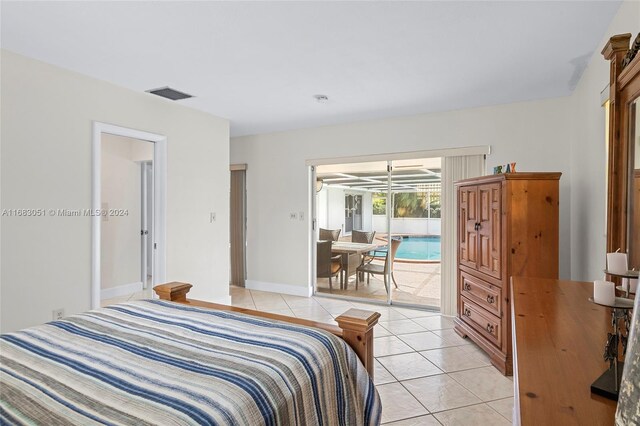 tiled bedroom featuring a chandelier and access to exterior