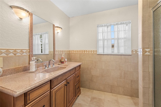 bathroom with vanity, tile walls, and plenty of natural light