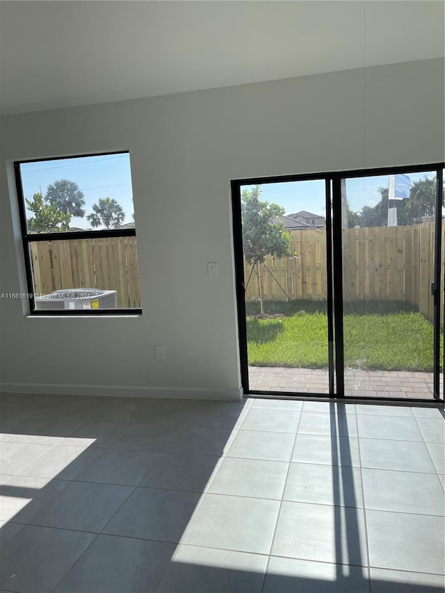empty room with tile patterned floors and baseboards