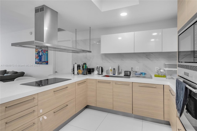 kitchen featuring island exhaust hood, light brown cabinets, stainless steel appliances, sink, and white cabinets